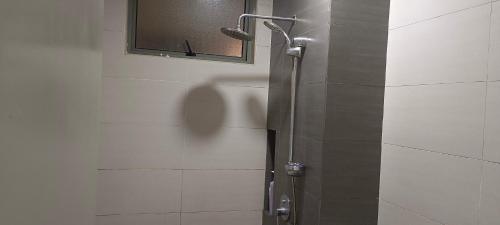 a shower stall in a bathroom with a mirror at Peace home apex in Cyberjaya