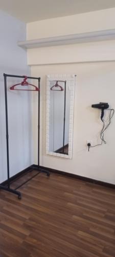 a room with two mirrors on a white wall at SY Staycation - Studio in Bayan Lepas