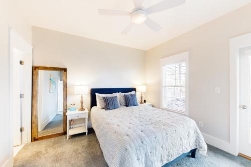 a bedroom with a bed and a mirror at Barefoot Cottages #B8 Jasmine by the Bay in Highland View
