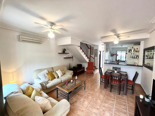 a living room with a couch and a table at Casa Rodasa - 2 bedrooms, roof terrace, Airco, Front-terrace, Back-Patio, communal pool, etc in Roda