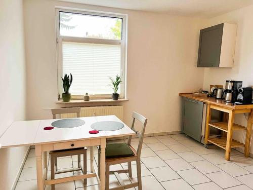 uma cozinha com mesa e cadeiras e uma janela em Qonroom - as individual as you - Wulferdingsen em Bad Oeynhausen