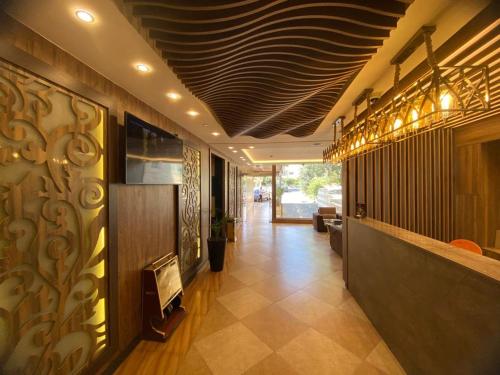 a hallway of a building with a bar in it at Al Mansi hotel in Amman