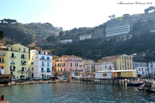 a view of a city with buildings and a body of water at Coltur Suites in Sorrento