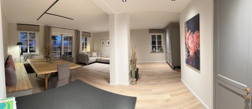 a living room with a table and a dining room at Meerblick Pelzerhaken in Neustadt in Holstein