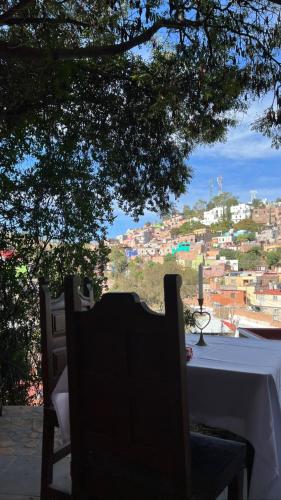 a table and chairs with a view of a city at Casa Diez-59 Guanajuato Capital in Guanajuato