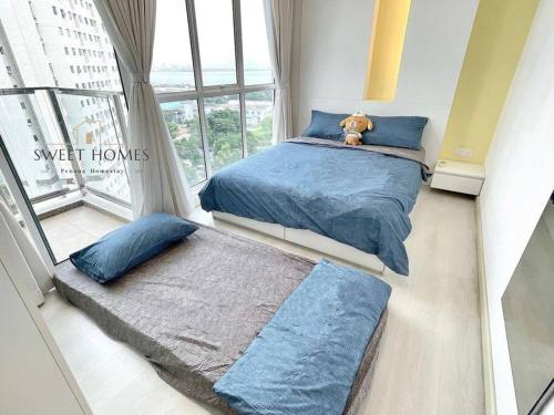 a bedroom with two beds and a teddy bear sitting on the bed at Pool View Stylish Suite at Jelutong Penang 1-4pax in George Town