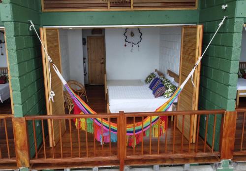 a porch with a hammock in a house at Casa Galú - Capurganá in Capurganá
