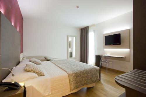 Ένα ή περισσότερα κρεβάτια σε δωμάτιο στο Hotel Marco Polo