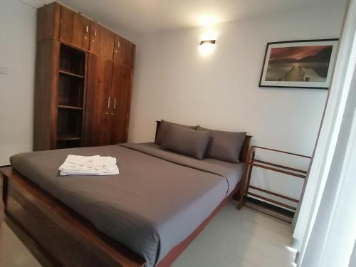 a bedroom with a bed with a towel on it at Moon Plains Luxury Apartments in Nuwara Eliya