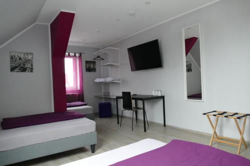 a room with a bed and a desk in it at Pension Sölde UG in Dortmund
