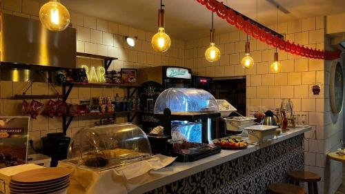 a kitchen with a counter with food on it at Safestay Bratislava Presidential Palace in Bratislava
