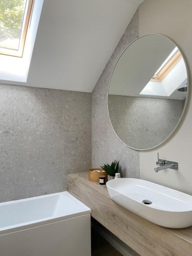a bathroom with a white sink and a mirror at Bieleniówka in Nakielno
