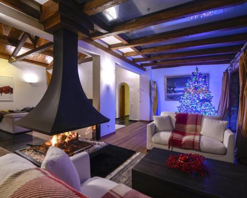 a living room with a christmas tree and a fireplace at Ferenity in Iraklitsa