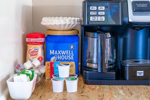 a shelf with cups and a coffee maker on it at The Estate at Mt Dora in Mount Dora