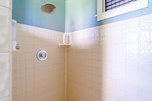 a bathroom with a shower with tiled walls and a window at The Estate at Mt Dora in Mount Dora