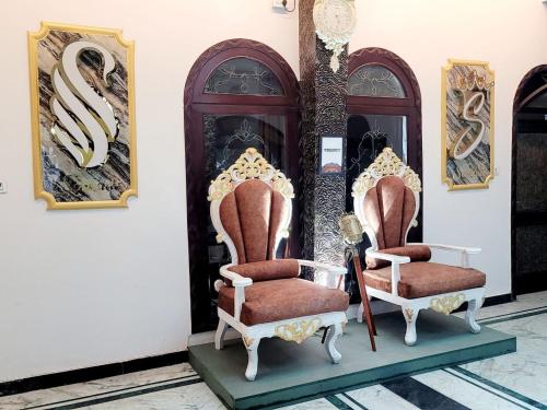 a pair of chairs on display in a room at Solitude, The Boutique Hotel in Haldwāni