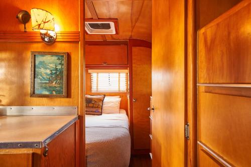 a small room with a bed and a small kitchen at The Vintages Trailer Resort in Dayton