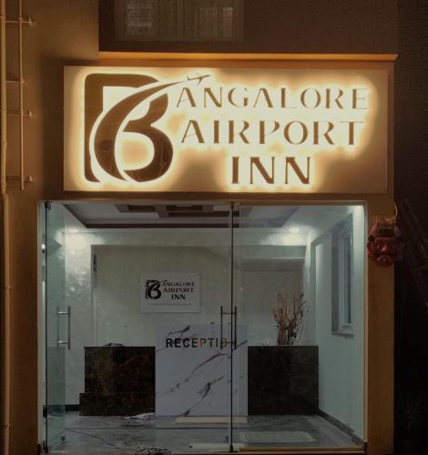 a sign for an autoclave entrance to an apartment inn at Hotel Bangalore Airport Inn, Near kempegowda Airport, Airport Pickup & Drop Available 24X7 in Bengaluru