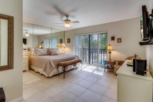 a bedroom with a bed and a large mirror at Land's End 10-201 Beach Front - Premier in St Pete Beach