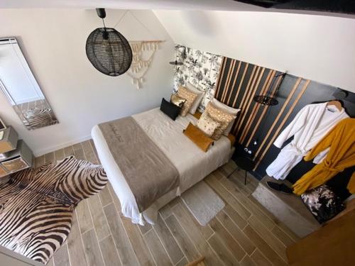 a bedroom with a bed and a person sitting in a chair at Entre Honfleur et Etretat in Octeville-sur-Mer