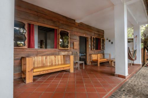 a room with a wooden wall with a bench at Esencia Nativa in El Zonte