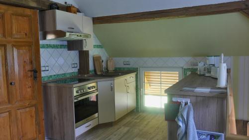 a kitchen with a stove and a counter top at Wjažka in Guhrow