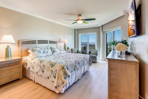 a bedroom with a large bed and a living room at Land's End 6-302 Beach Front - Premier in St Pete Beach