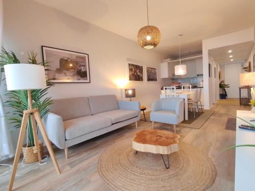 a living room with a couch and a table at Santa Cruz Ocean Apartment - I in Santa Cruz