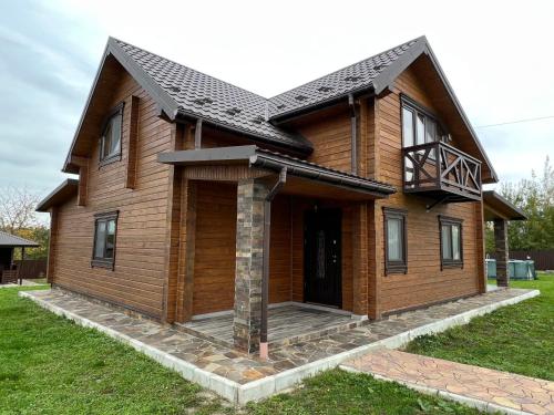 a wooden house with a gambrel roof at Villa Family House Truskavets in Modrychi