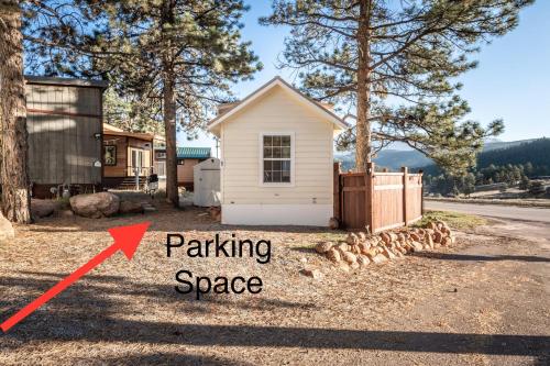 a tiny house with a arrow pointing to a parking space at NEW! Boutique TinyHome w/Direct View of PikesPeak! in Woodland Park