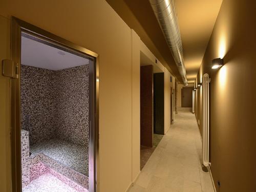 a hallway with a door leading to a corridorngthngthngthngthngthngthngth at Borgo Fantino - Residenze e Alloggi Vacanza in Limone Piemonte