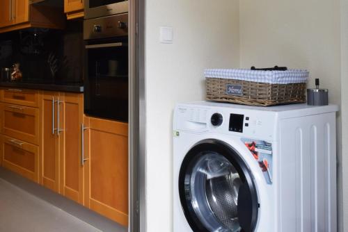a washing machine with a basket on top of it at Machico Beach, a Home in Madeira in Machico