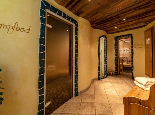 a room with a door open to a tasting room at Sport & Familienhotel Bärenwirt in Aich
