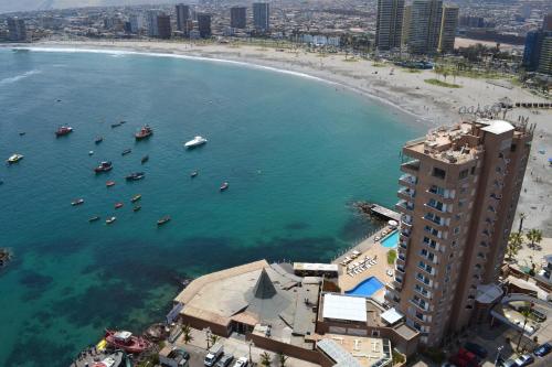an aerial view of a beach with boats in the water at Terrado Suites Iquique in Iquique