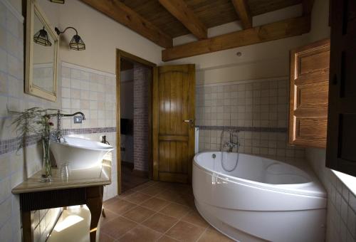 a bathroom with a large tub and a sink at Posada Los Condestables Hotel & Spa in Villalpando