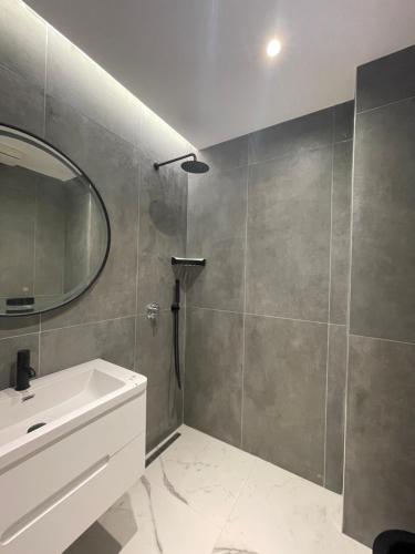 a bathroom with a sink and a mirror at Ladi Rooms in Tirana