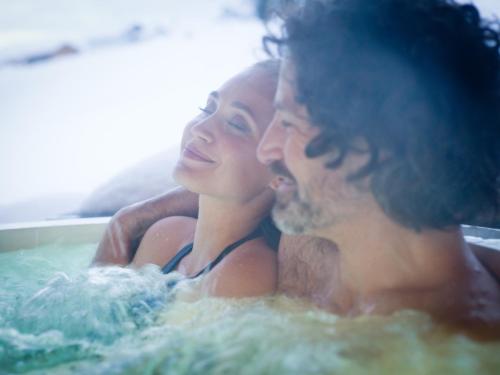 two women are sitting in a bath tub at Euler Neuschönau - Naturhotel & Chalets in Neuschönau