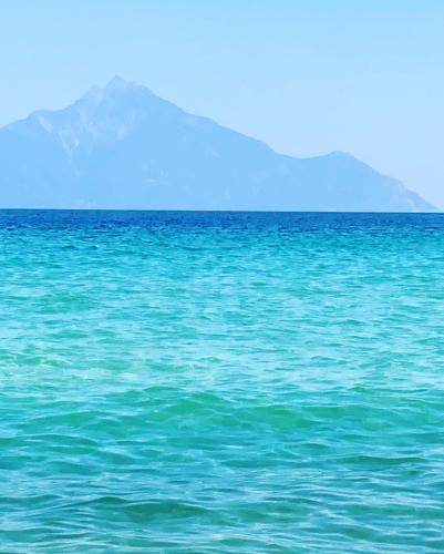 a large body of water with a mountain in the background at Villa Ulyana Sarti - Ancient Greece in Center in Sarti