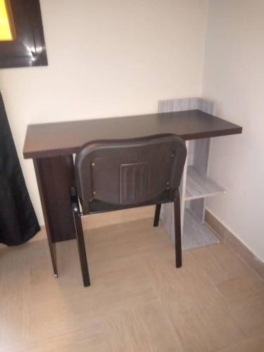 a wooden desk with a chair in a room at Keur Mado in Dakar