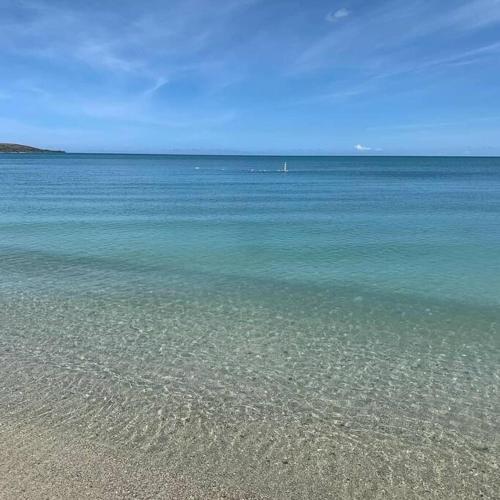 a large body of water with a sandy beach at Beautiful beachside apartment w/ terrace, balcony. in Arenas
