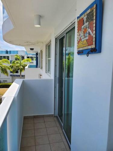 a hallway of a house with a white wall at Beautiful beachside apartment w/ terrace, balcony. in Arenas