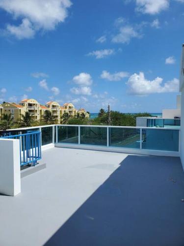 a balcony with a blue railing on top of a building at Beautiful beachside apartment w/ terrace, balcony. in Arenas