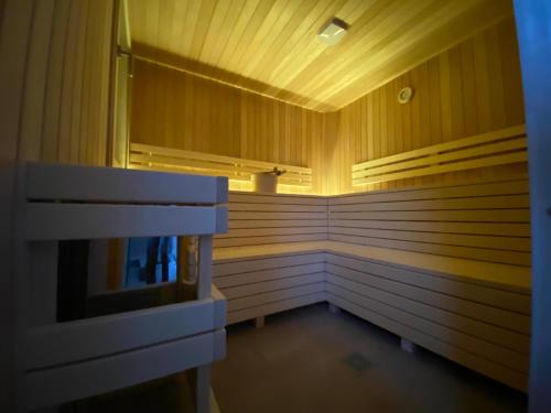 a sauna with wooden walls and wooden floors and avisor at BERGLAGE - Das UrlaubZuhause - Ferienhäuser in Braunlage