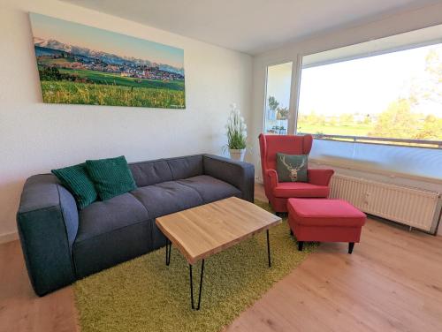 a living room with a couch and two chairs at Ferienwohnung BergOase mit Pool & Sauna in Scheidegg