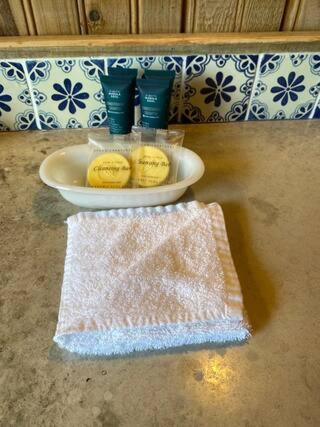a table with a plate and a bowl on a table at Ocean Breeze Villa Rentals in Oak Ridge