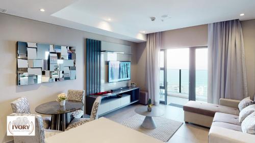 a living room with a couch and a tv at Oceans Apartments Balcony Suites in the Radisson Blu Hotel Building Tower,Durban,Umhlanga in Durban