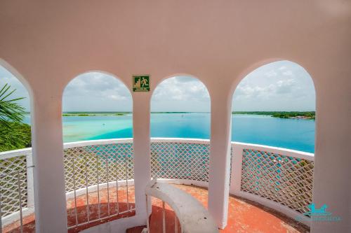 a view of the water from the balcony of a house at Casa Árabe in Cenote Azul
