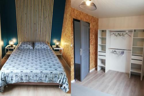 a bedroom with a bed and a blue wall at L'Autre Maison in Lucet