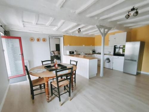 a kitchen and dining room with a table and chairs at L'Autre Maison in Lucet