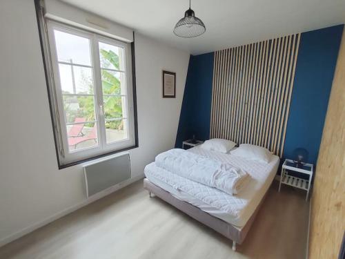 a bedroom with a bed with a large window at L'Autre Maison in Lucet